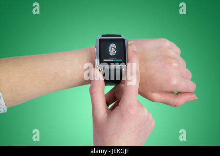 Composite image of woman using smartwatch Banque D'Images