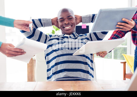 Portrait of businessman relaxing in office Banque D'Images