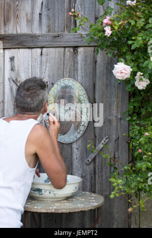 Rasage homme mature en plein air Banque D'Images