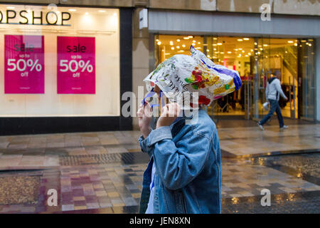 Penwortham, Lancashire, Royaume-Uni. Météo britannique. 27 Juin, 2017. De fortes pluies dans la ville avec unseasonal conditions météo de la district de détail. Des pluies torrentielles font qu'il est difficile pour les acheteurs qui ont du mal avec les fortes rafales de vent et les rafales. La prévision est de poursuivre et de fortes pluies persistantes souvent lentement vers l'Est, avec de forts vents. /AlamyLiveNews MediaWorldImages crédit ; Banque D'Images