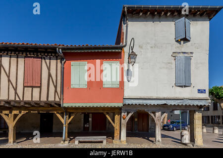 La ville de Mirepoix. Maisons colorées à colombages sont pris en charge sur des piliers de bois, créant une magnifique arcade couverte colorée ronde place centrale. Banque D'Images