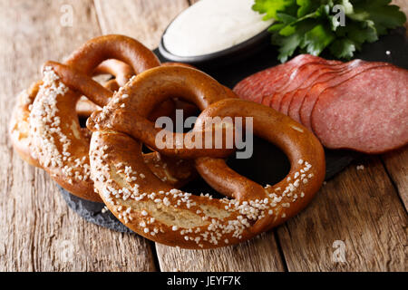 Bretzels salés allemand, de salami et de la sauce sur la table. L'horizontale Banque D'Images