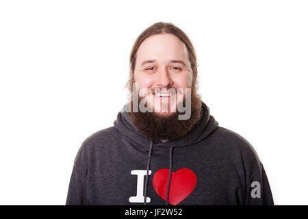 Une soignée, beau, barbu dans un sweat-shirt noir et une bonne expression sur son visage. Banque D'Images