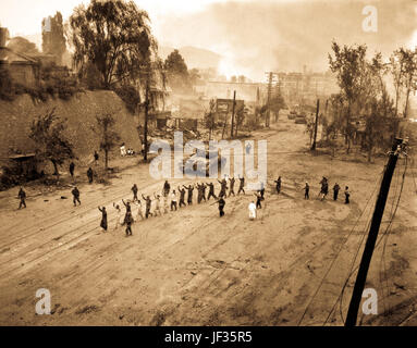 Un réservoir de Marines des États-Unis suit une ligne de prisonniers de guerre dans un village-rue. Le 26 septembre 1950. Photo par S. Sgt. John Babyak, Jr. (Marine Corps) Banque D'Images