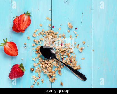 Muesl sec avec cuillère à thé noir et de fraises fraîches Banque D'Images