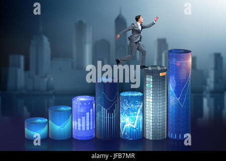 Businessman jumping over bar charts Banque D'Images