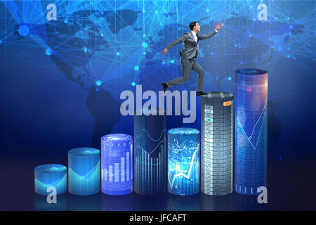 Businessman jumping over bar charts Banque D'Images