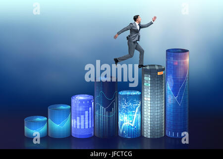 Businessman jumping over bar charts Banque D'Images