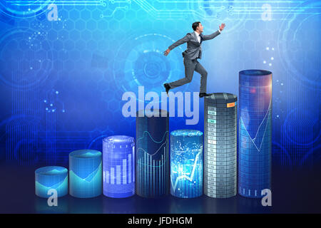 Businessman jumping over bar charts Banque D'Images