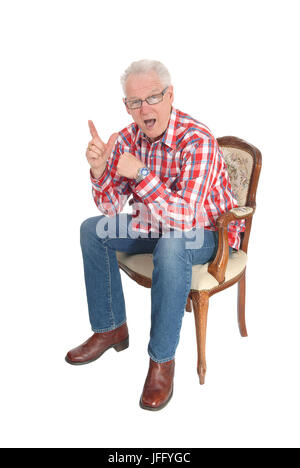 Senior man sitting surpris. Banque D'Images