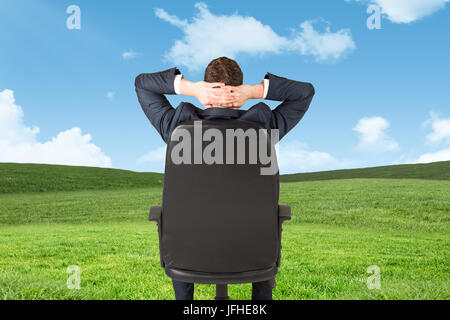 Image composite de businessman sitting in swivel chair Banque D'Images