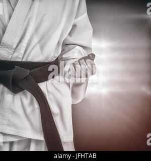 Image composite de l'athlète féminin posant en kimono Banque D'Images