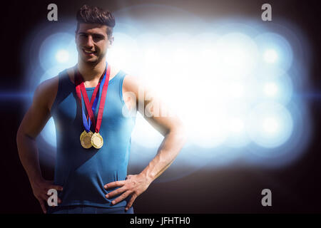 Composite image of athletic man holding médailles Banque D'Images