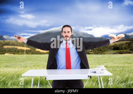 Composite image of businesswoman sitting with arms outstretched Banque D'Images