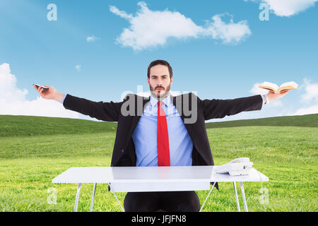 Composite image of businesswoman sitting with arms outstretched Banque D'Images