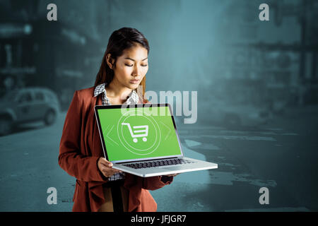 Portrait of businesswoman showing a laptop Banque D'Images