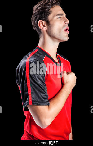 Faire preuve de respect de l'athlète pendant l'hymne national sur fond noir Banque D'Images