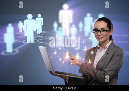 Businesswoman with laptop in social network concept Banque D'Images