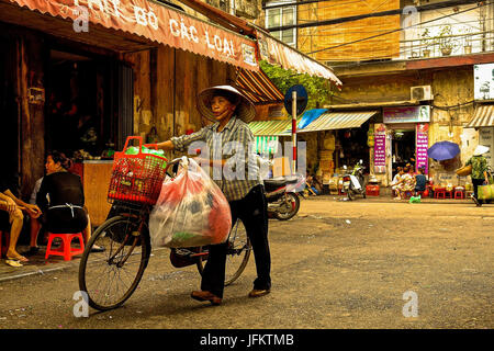 Les résidents, les vendeurs de rue et commerçants vaquaient à leurs activités quotidiennes dans le vieux quartier de Hanoi, Vietnam Banque D'Images