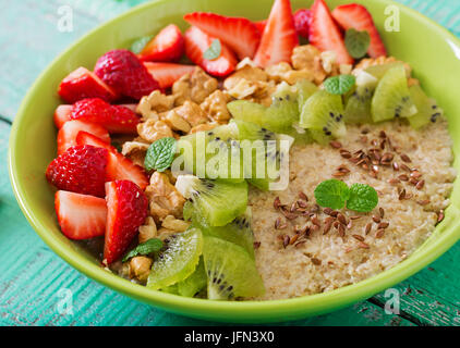 Porridge d'avoine sains et savoureux avec des notes de petits fruits, noix et graines de lin. Petit déjeuner sain. Alimentaire de remise en forme. Une bonne nutrition Banque D'Images