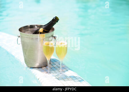 Seau glace Bouteille de champagne et deux verres près de smimming pool Banque D'Images