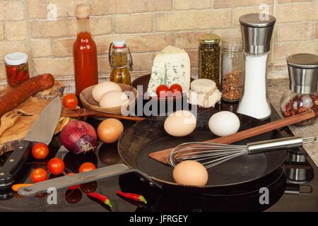 Poêle en acier sur la cuisinière. Des ustensiles de cuisine. Préparation de l'omelette d'oeufs. Alimentation nourriture Banque D'Images