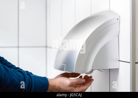 Le sèche-mains mural carrelage blanc dans la salle de repos Banque D'Images