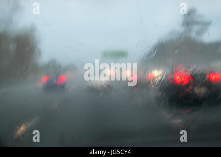 La conduite avec les fortes pluies du pare-brise de voiture sur l'autoroute 1, Auckland, Nouvelle-Zélande, NZ - voiture en face n'a pas de phares sur Banque D'Images