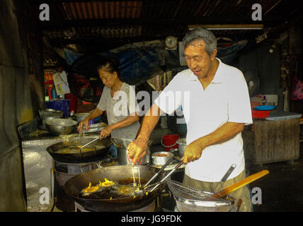 Deux cuisiniers chinois sauté dans un restaurant à Georgetown, Penang, Malaisie Banque D'Images