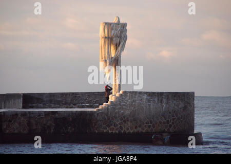 Un horizon de glaçons sur la lampe sur la jetée du port gelé de l'hiver. par la mer. Banque D'Images