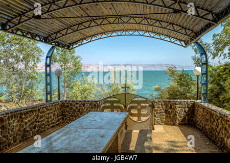 Un abri ombragé dans le jardin de l'Église grecque orthodoxe des sept apôtres, avec vue sur la mer de Galilée, Capharnaüm, Israël. Banque D'Images