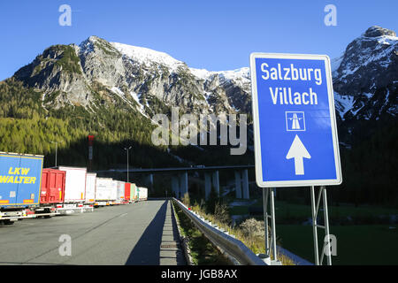 FLACHAU, Autriche - 10 MAI 2017 : un panneau routier pour Salzburg-Villach avec camions stationnés à la halte routière Tauernalm Landzeit dans Alpes env Banque D'Images