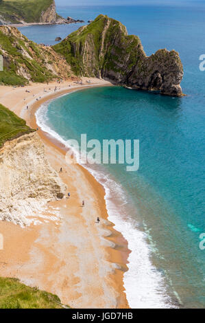 Durdle Door, Dorset touris attraction vue du côté ouest. La lumière de l'après-midi ensoleillé avec des nuages sur ciel bleu et la mer d'azur. Banque D'Images