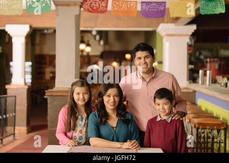 Portrait of smiling Hispanic family in restaurant Banque D'Images