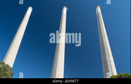 Les cheminées d'usine industrielle contre un ciel bleu Banque D'Images