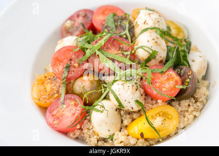 Une bonne salade de tomates cerises et mozzarella sur un lit de quinoa Banque D'Images
