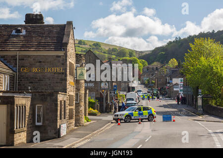 Près de la police de la route principale traversant le village après une collision entre un cycliste et voiture à Hathersage, Peak District, Derbyshire, Angleterre, RU Banque D'Images