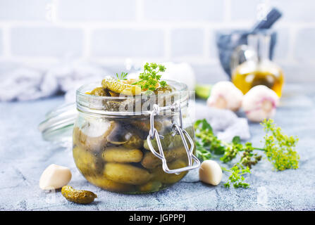 Picled au concombre et banque en verre sur une table Banque D'Images