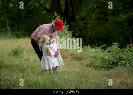 Grindleford Derbyshire, Royaume-Uni. 09 juillet 2017. A 78 ans, grand-père s'occupe de ses deux petits-enfants jumeaux, Minnie et Tillie, âgée de trois ans, à Padley Chapelle, où des centaines de catholiques du diocèse de Hallam et Nottingham assister à la messe à l'Assemblée Padley pèlerinage . Le pèlerinage a débuté en 1898 à l'honneur deux prêtres catholiques, Nicholas Garlick et Robert Ludlum, qui, après avoir été ordonnés prêtres sur le continent, de haute trahison commis par son retour en Angleterre. Ils ont été arrêtés à Padley Manor et exécuté à Derby en 1588. Crédit : John Fryer/Alamy Live News Banque D'Images