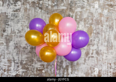Bouquet de ballons lumineux contre un mur texturé. Copy space Banque D'Images