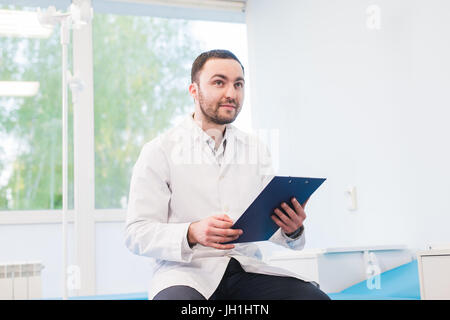 Portrait of handsome young doctor in office Banque D'Images
