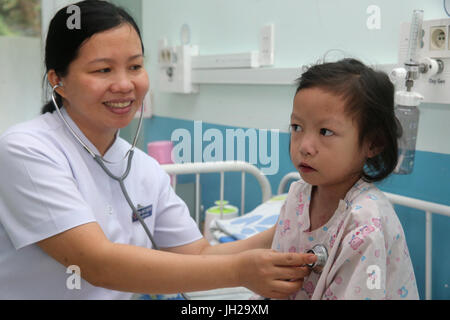 L'Institut de Cardiologie offre des soins de haute qualité aux patients vietnamiens souffrant de maladies du cœur. Médecin à l'écoute de coeur de jeune fille. Ho Chi Minh Banque D'Images