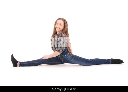 Jeune fille en jeans assis sur la ficelle isolated on white Banque D'Images