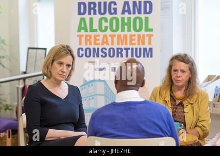 Secrétaire d'accueil parle à Rudd Ambre travailleur clé Ken Davis et center manager Dawn Brecken (à droite), lors d'une visite à l'Harbour Centre de récupération à Brixton, dans le sud de Londres avant le lancement d'une nouvelle stratégie antidrogue le vendredi 14 juillet. Banque D'Images