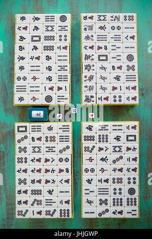 Tuiles de Mahjong '麻將' sur fond en bois vert, plat Banque D'Images