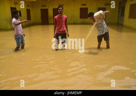 Jodhpur, Inde. 14 juillet, 2017. Patauger par résidents patauger dans la rue inondée après de fortes pluies à Jodhpur, Nagaland le jeudi 14 juillet, 2017. La mousson du sud-ouest qui frappe la région de l'Asie du Sud-Est à partir de juin à septembre l'origine d'importants inondations chaque année. Credit : Caisii Mao/Alamy Live News Banque D'Images