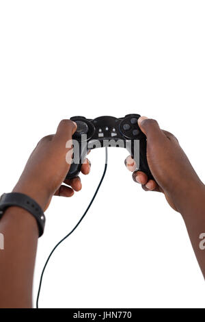 Close-up of mans hand playing video game against white background Banque D'Images