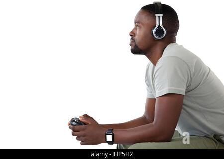 Side view of man playing video game against white background Banque D'Images