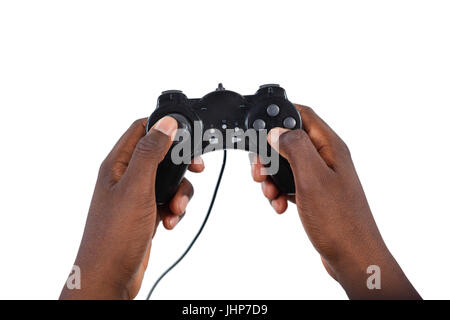 Close-up of mans hand playing video game against white background Banque D'Images