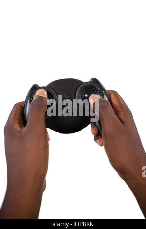 Close-up of mans hand playing video game against white background Banque D'Images